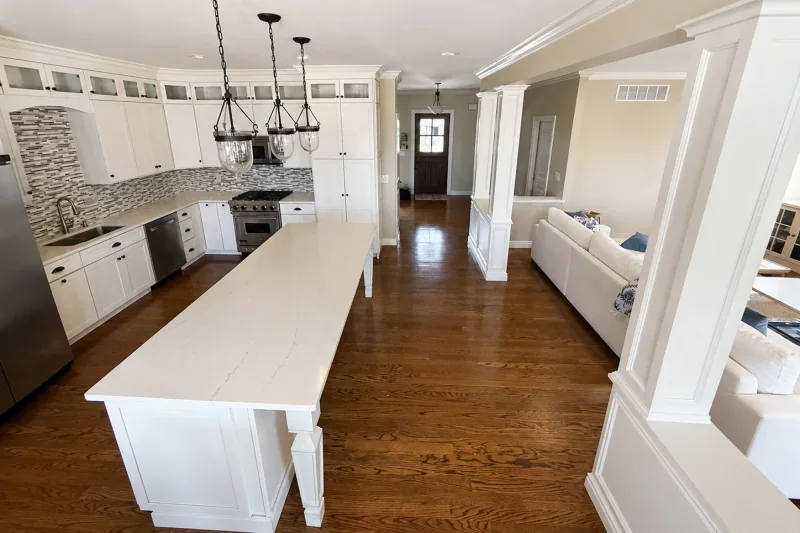 Open-concept kitchen and living room with continuous refinished red oak hardwood flooring in a Point Pleasant NJ home