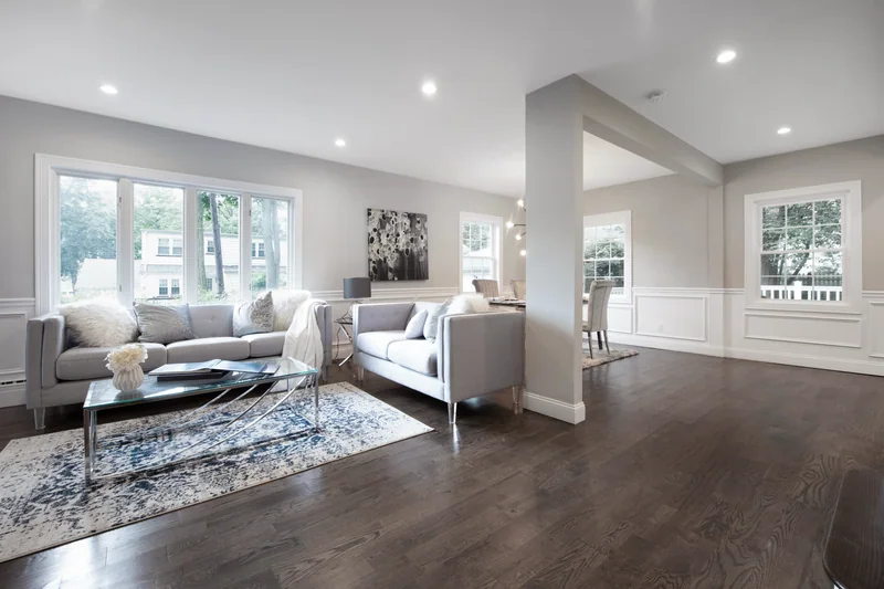 Dark hardwood running from a staged living room through to the dining area