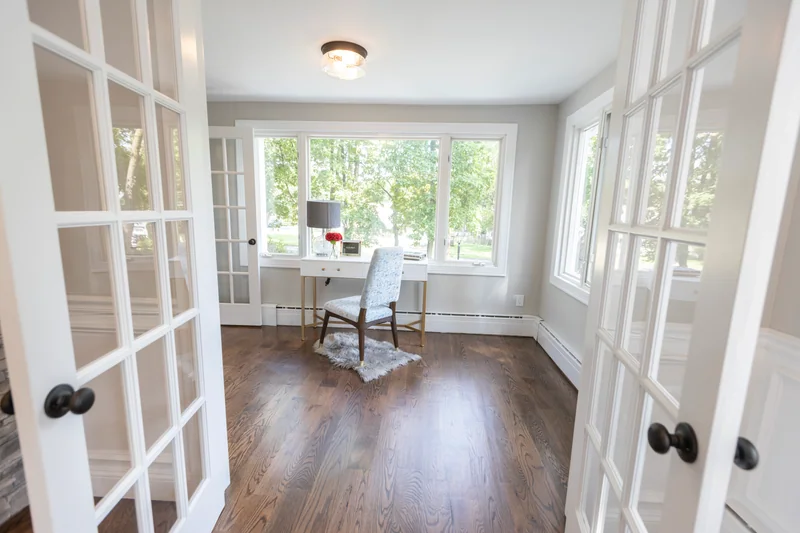 Dark hardwood in a home office seen through a pair of glass French doors