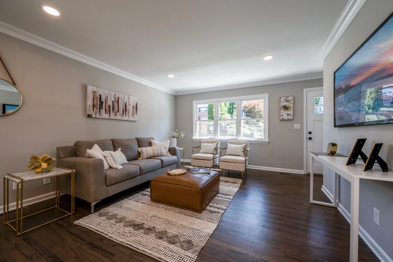 Dark hardwood in a staged living room looking toward the front door