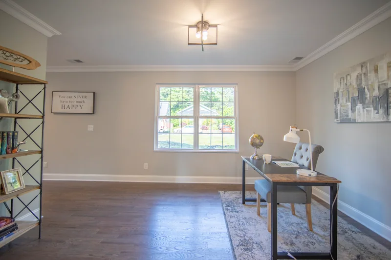 Medium-brown hardwood in a small office with a wood desk and open shelving