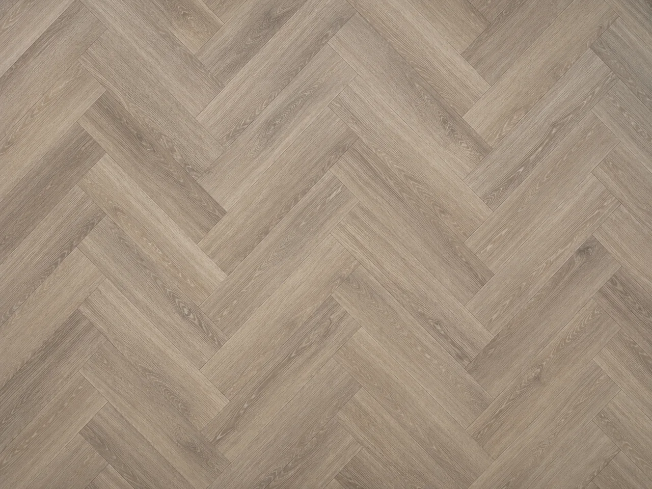 Flat-lay of greige-oak luxury vinyl planks in a herringbone pattern